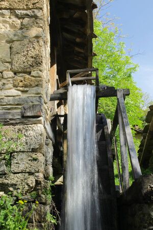 Flow of water from a water mill in the village