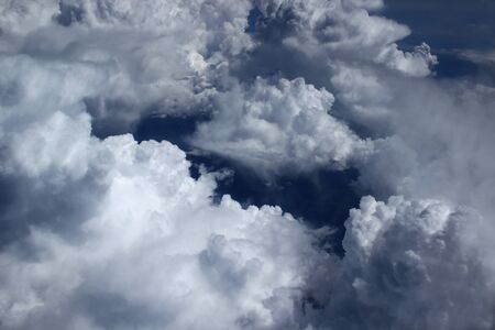 View of clouds from the aircrafts porthole in flight