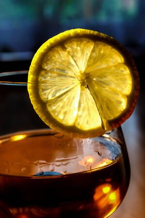 A slice of lemon on a glass with cognacの写真素材