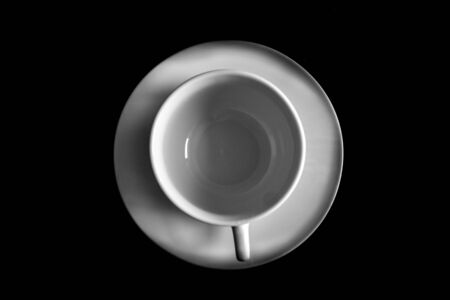 Coffee cup on a saucer on a black backgroundの写真素材
