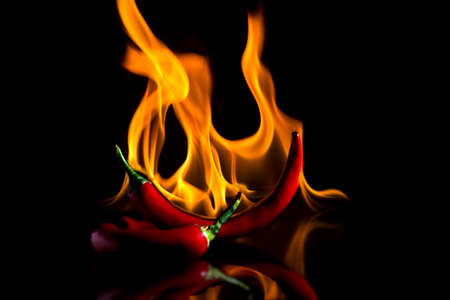 Red pepper on fire with reflection