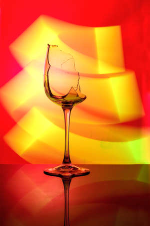 Art photo of a glass with multi-colored lighting