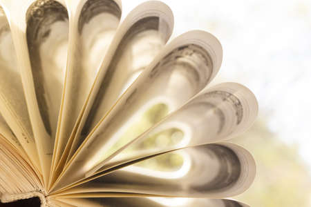 Pages of an unfolded book with a binding on a colorful background.の写真素材