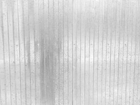 Profiled metal fence made of galvanized steel with traces of corrosionの写真素材