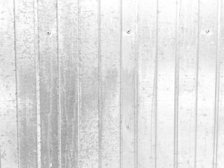 Profiled metal fence made of galvanized steel with traces of corrosionの写真素材