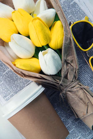 Bouquet of multi-colored tulips in paper wrapping on the newspaper. Celebrating. . International Womens Day. Spring.の写真素材