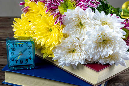 Notebooks, books and flowers on a wooden table. Design. Education. Businessの写真素材