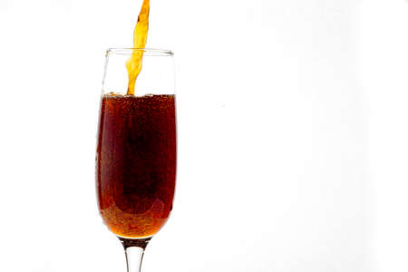 Carbonated drink is poured into a crystal wine glasse. Design. Bubbles