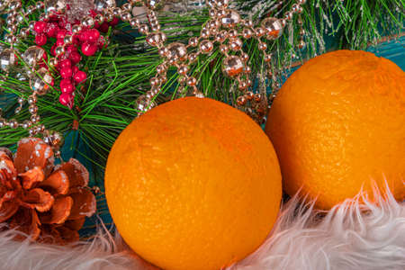 New Years mood. Oranges with Christmas tree branches and Christmas decorationsの写真素材