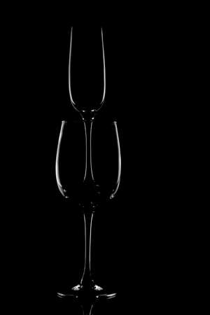 The outline of glass glasses on a black background. Form. Lightの写真素材