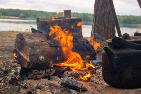 Kettle in the smoke of a campfire on a hikeの写真素材