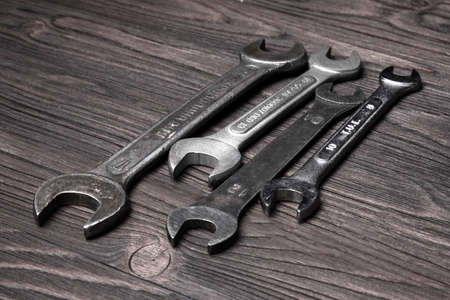 Old wrenches on a wooden table