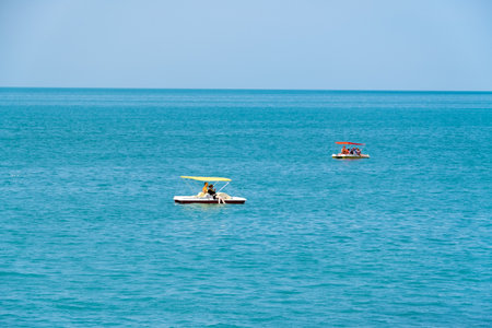 Abkhazia Gagra 06.06.2023 Vacationers of Grand Abkhazia and Amza hotels ride on the waves on a catamaranのeditorial素材