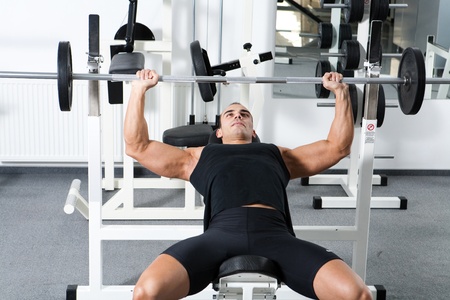 young bodybuilder training in the gym: chest - barbell incline bench press - wide grip の写真素材