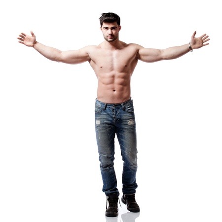 full body shot of a handsome young man, wearing blue jeansの写真素材
