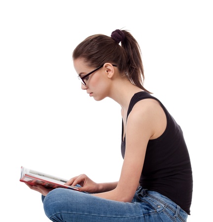 portrait of beautiful teen girl with a book, isolated on white backgroundの写真素材