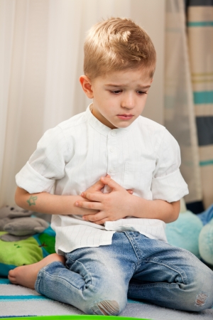 A five year old child having an abdominal painの写真素材