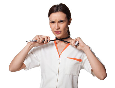 creative photo of a nurse or medicine student hanging herself with the stethoscope; beautiful young doctor with stethoscope, wearing white uniform, isolated on white backgroundの写真素材