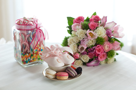 Coloured arrangement of macaroons, candy flowers for a little girl baptism partyの写真素材