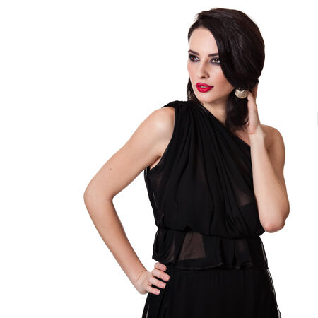 Beautiful caucasian woman isolated on white backround looking to the left with one hand in her hairの写真素材