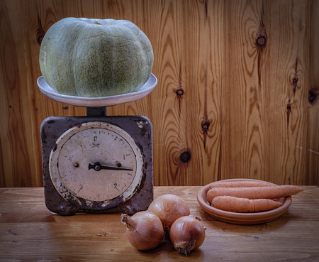 Pumpkin on the scales. Onions and carrots.の写真素材