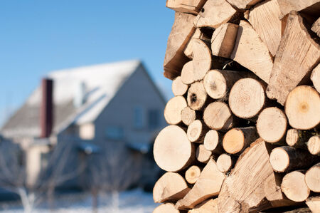 Stacked wood outside in the sun