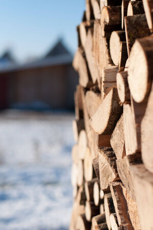 Stacked wood outside in the sunの写真素材