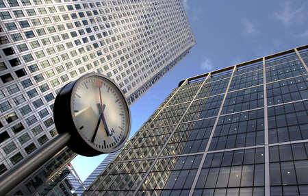 clock and office buildingsの写真素材