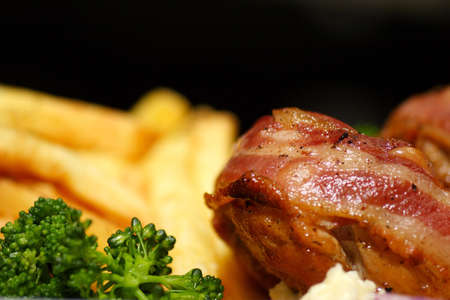 turkey medallion stuffed with kymac cheese and bacon served with french fries  and green vegtablesの写真素材