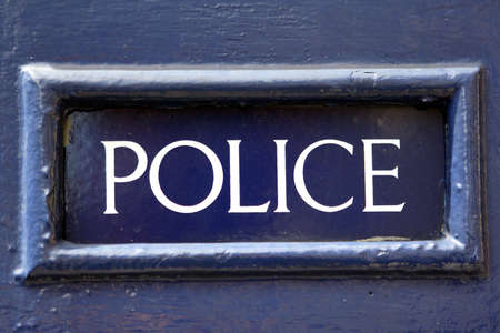 old police sign in frame painted blueの写真素材