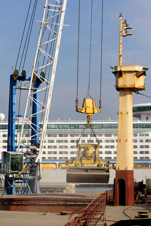 freight ship being loaded with aggregate on dockside
