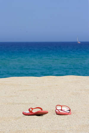 flip flops on empty sandy beach, corsica, mediterraneanの写真素材
