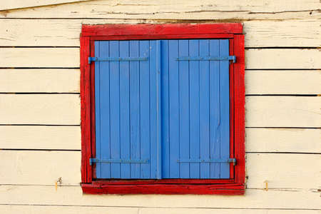 painted window shutters on beach hut, corsicaの写真素材