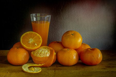 oranges and glass of juice on a wooden table. / Still life fruit.の写真素材