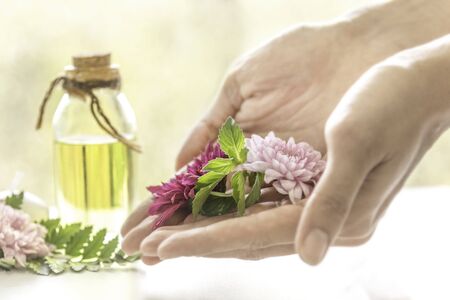 Aromatic oil extract from flowers. Fragrant oil Ready to use in a refreshing spa. Aroma massage, beautiful body skin, hand skin care, fragrance from fresh flowers. Banner website image.の写真素材