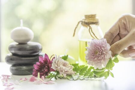 Aromatic oil extract from flowers. Fragrant oil Ready to use in a refreshing spa. Aroma massage, beautiful body skin, hand skin care, fragrance from fresh flowers. Banner website image.の写真素材