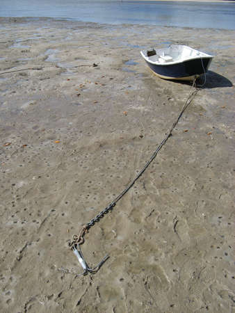 High and dry - dingy on sand bar at low tideの写真素材