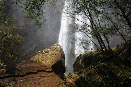 Waterfall behind rocks