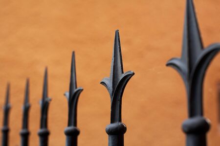 Tips on a fence, one in focus の写真素材