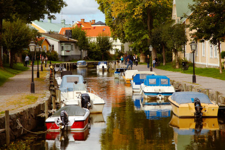 Trosa, Sweden - September 15, 2012: A sunny September day at Trosa River in Trosa with the pleasure craft moored out with quays along the river.のeditorial素材