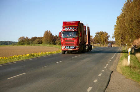 J?a, Sweden - September 15, 2012: Truck on driving south on the highway between J?a and Vagnh?d (old E4). The road is lined with a field of sunflowers.  のeditorial素材
