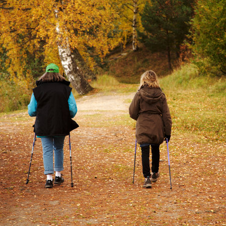 Two women exercising nordic walking at Eklundsn?in S?t?e, Sweden.  のeditorial素材