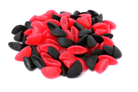 A pile of licorice and raspberry boats isolated on a white background   の写真素材