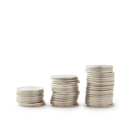 Economic growth is symbolized by three stacks of coins on white background   の写真素材