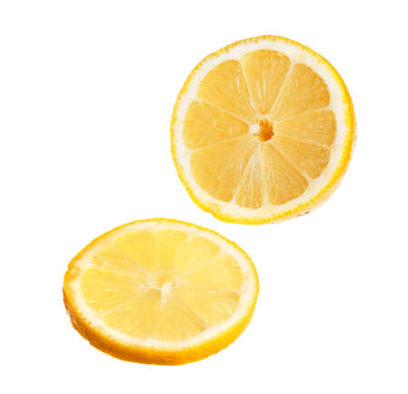 A sliced yellow lemon isolated on white background の写真素材