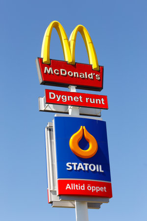 Eskilstuna, Sweden - June 14, 2014  Signs at Vasterleden for the fast food hamburger restaurant McDonalds and the Statoil service station isolated on blue sky  Both are newer closed のeditorial素材