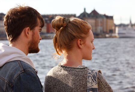 A young couple in front of the Old town in Stockholm, Sweden.の素材