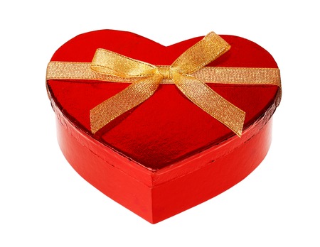 One heart shaped unopend red glossy gift box with a golden ribbon, isolated on white background.の写真素材