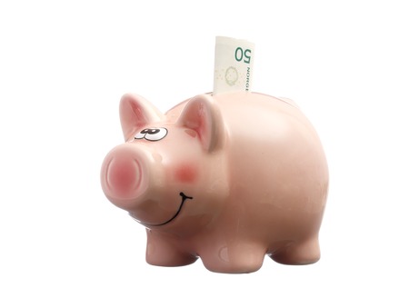 Pink piggy bank with a Norwegian 50 kroner, isolated on white background.の写真素材