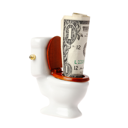 One US dollar banknote in a miniature toilet, isolated on white background.の写真素材